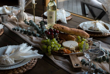 Load image into Gallery viewer, Set table with wine baguette cheese board fruit and decor

