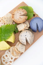 Load image into Gallery viewer, Cheese board seen from above with cheese wheels, crackers, lotus root slices and garnish
