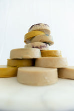Load image into Gallery viewer, A stack of cheese wheels
